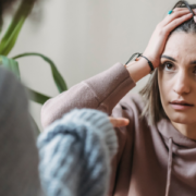 An anxious woman with her hands on her head