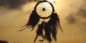 A dreamcatcher hanging outside in the sun